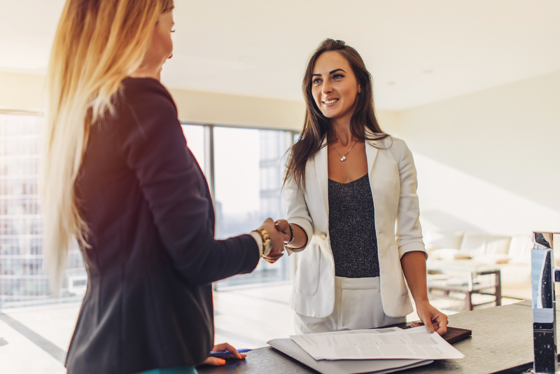 Female customer shaking hands with real estate agent